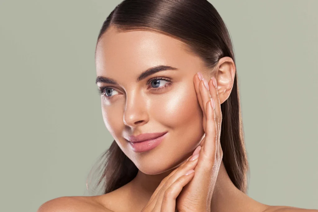 Woman with healthy skin touching her face, Dermatology West