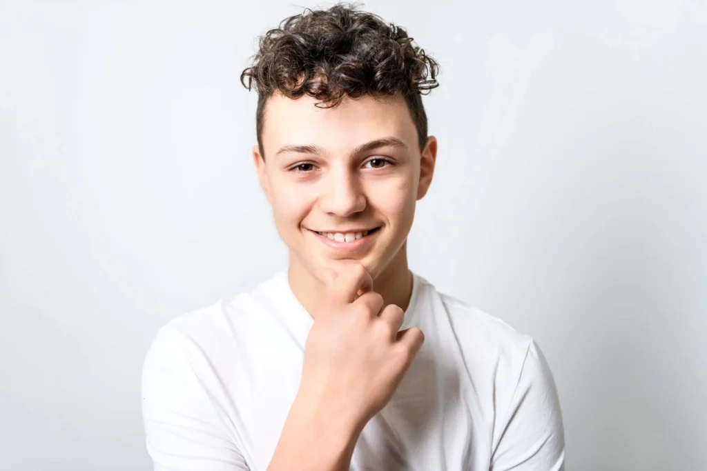 A smiling young man with clear, healthy skin.